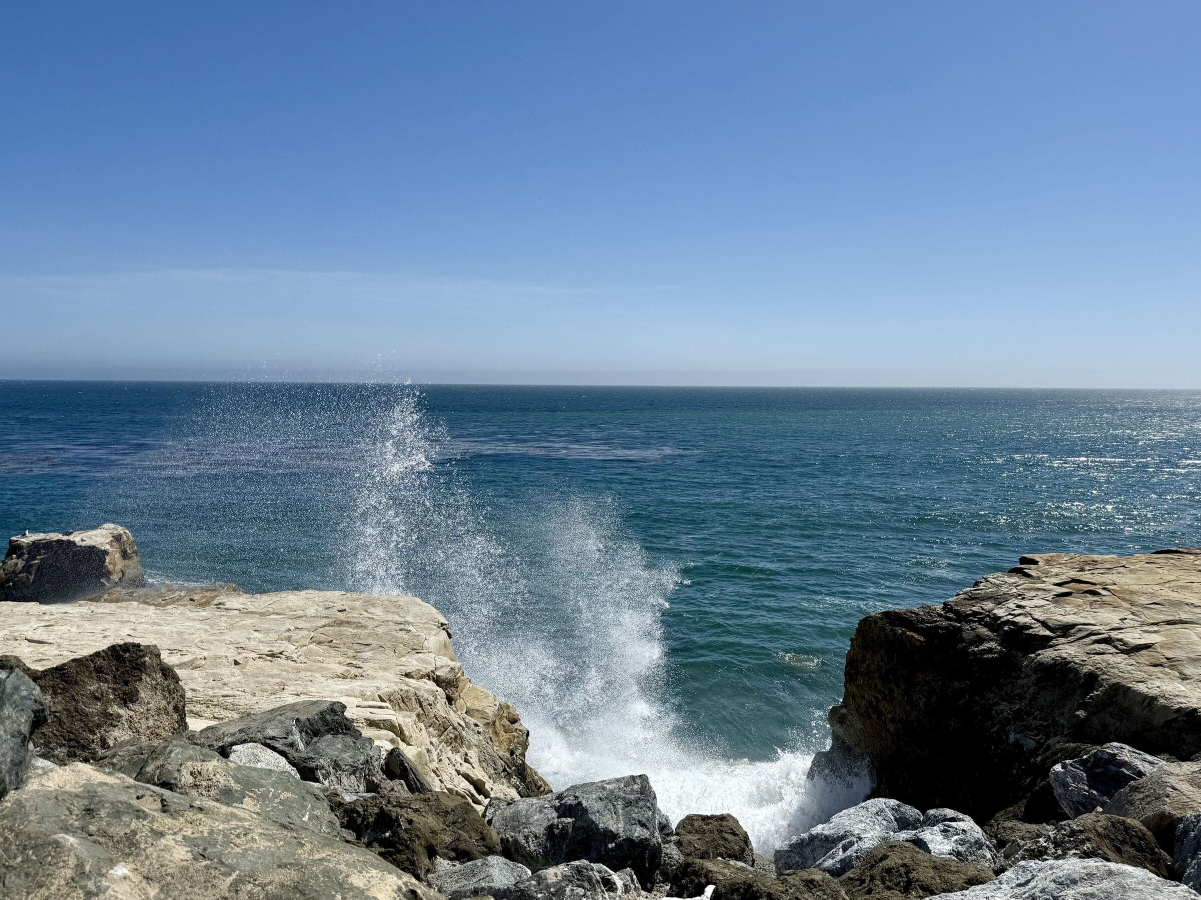 Ocean spray from a wave crashing on coastal rocks, Santa Cruz